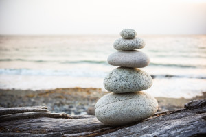 Inukshuk cairn on driftwood on beach in Alaska