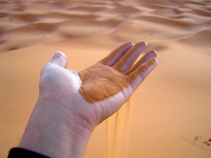 Hand with sand in Morocco