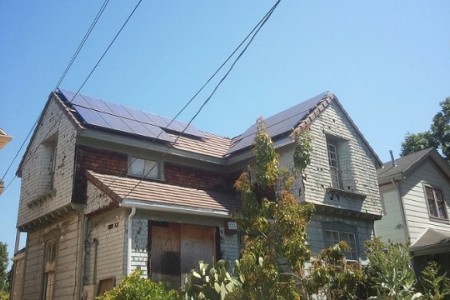Solar panels on a building with a boarded window