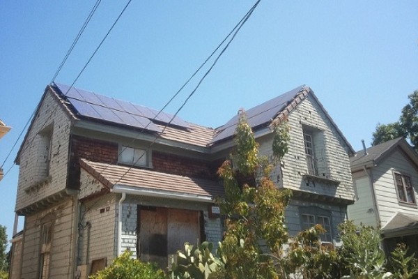 Solar panels on a building with a boarded window